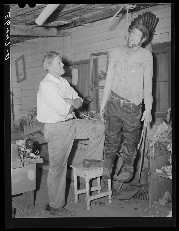 Homer Tate, self-trained artist, looking at his model of a hanged horse thief. Safford, Arizona