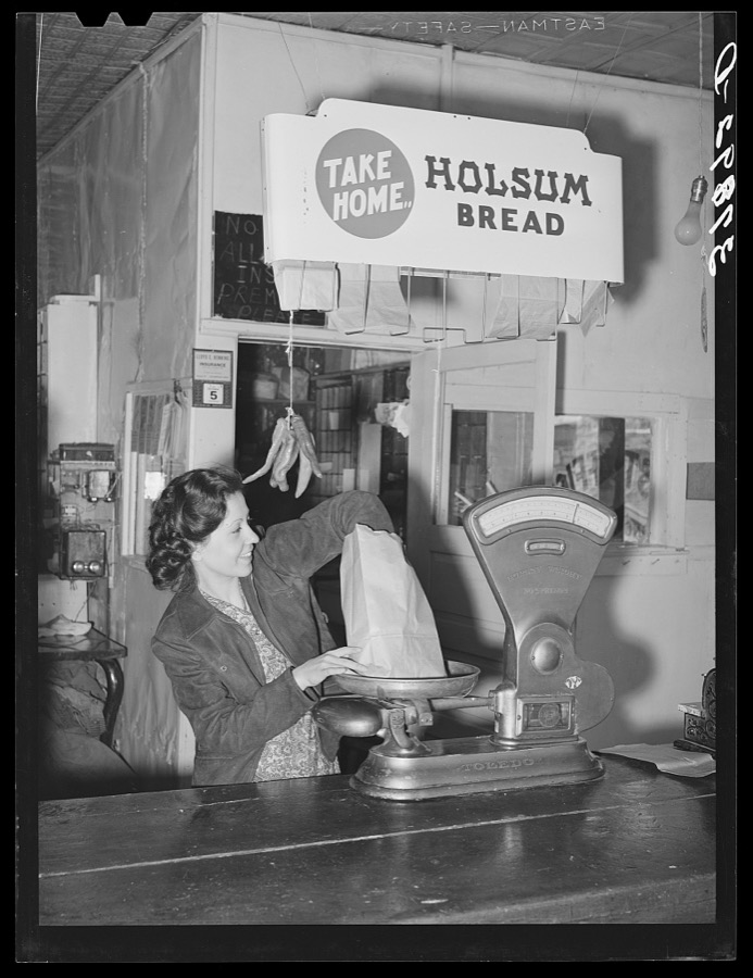 Grocery clerk weighing up potatoes. Concho, Arizona