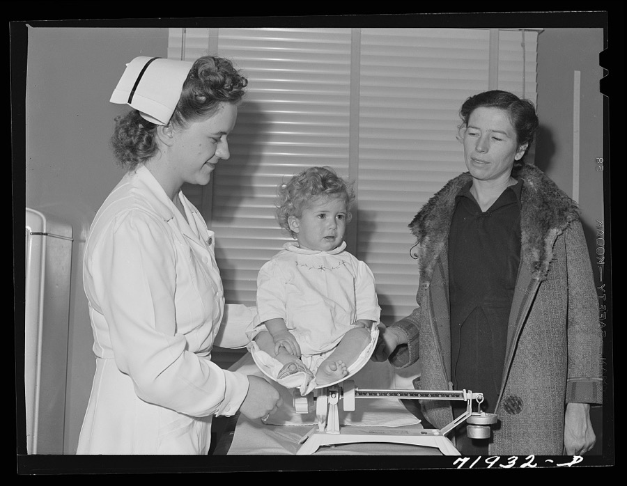 Baby is weighed at the well baby clinic which is held weekly at the Cairns General Hospital at the FSA (Farm Security Administration) farm workers' community. Eleven Mile Corner, Arizona