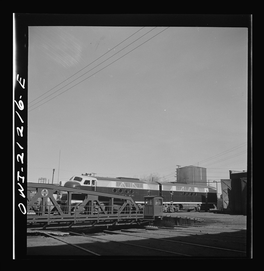 Winslow, Arizona. Two sections of a diesel freight engine coming out of the roundhouse in the Atchison, Topeka and Santa Fe Railroad yard. The completed engine will have four sections
