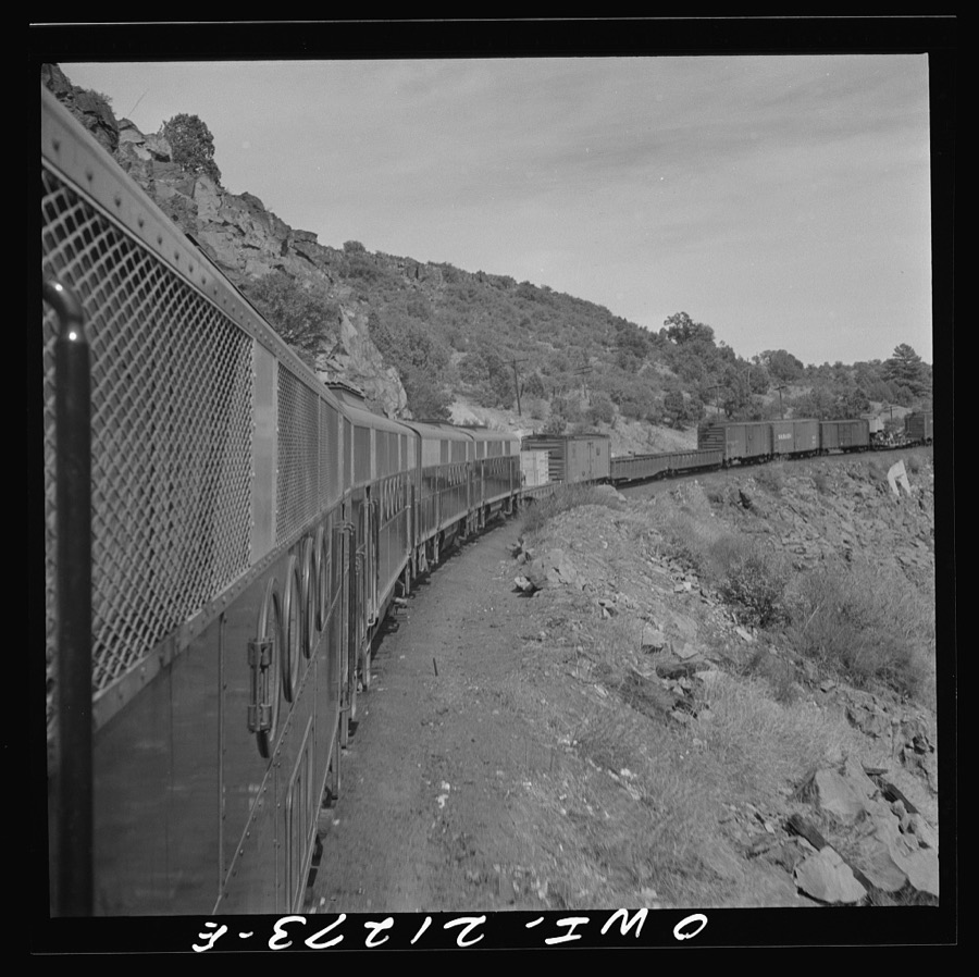 Williams, Arizona. A diesel freight train climbing through mountainous area along the Atchison, Topeka, and Santa Fe Railroad between Winslow and Seligman, Arizona
