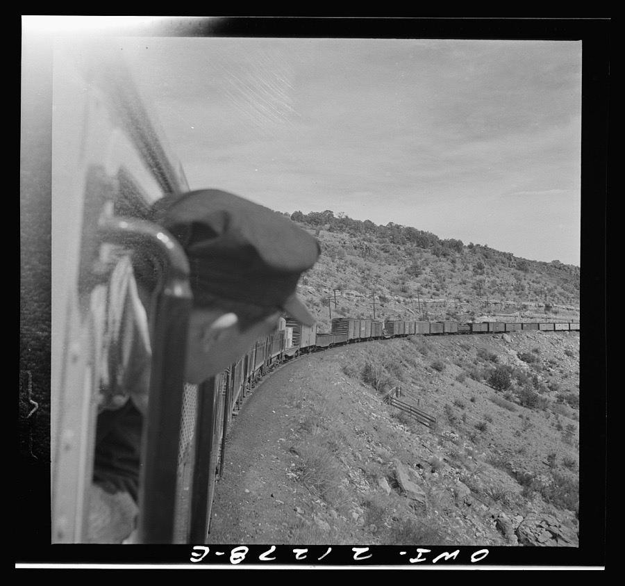 Williams (vicinity), Arizona. A train on the Atchison, Topeka and Santa Fe Railroad between Winslow and Seligman, Arizona coming out of a tunnel through the hillside