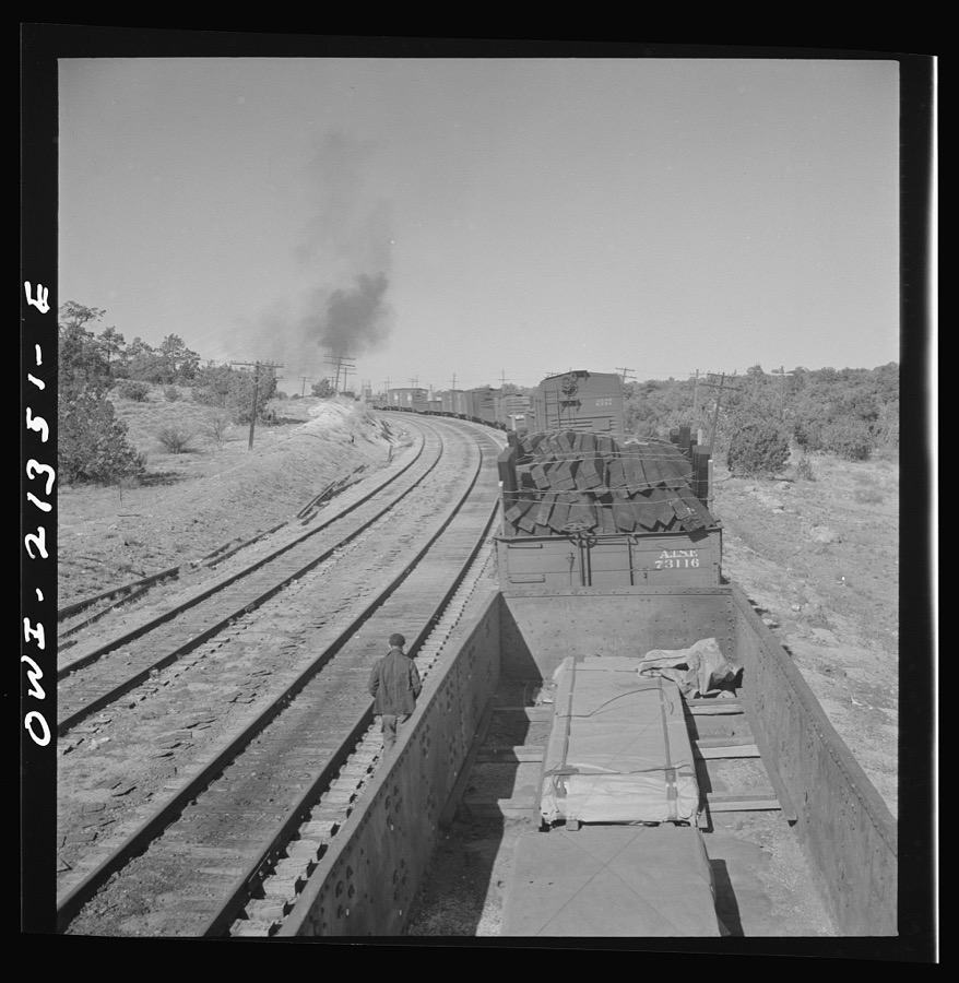 Yampai, Arizona. Brakeman and the conductor inspecting the train during a stop on the Atchison, Topeka, and Santa Fe Railroad between Seligman, Arizona and Needles, California