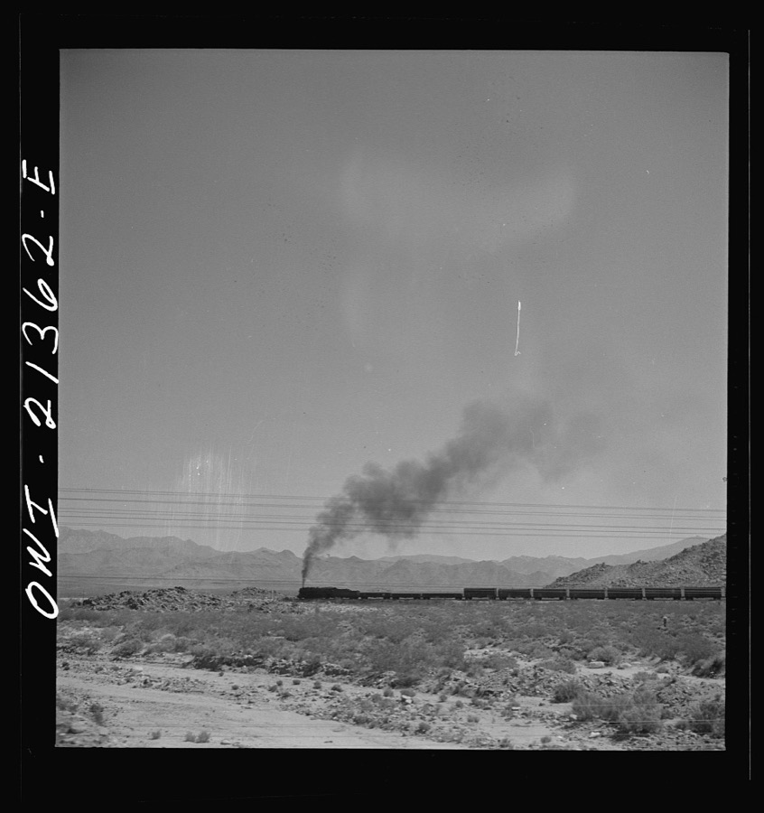 Kingman (vicinity), Arizona. A train on the Atchison, Topeka and Santa Fe Railroad between Seligman, Arizona and Needles, California going around a curve in the Walapai flats