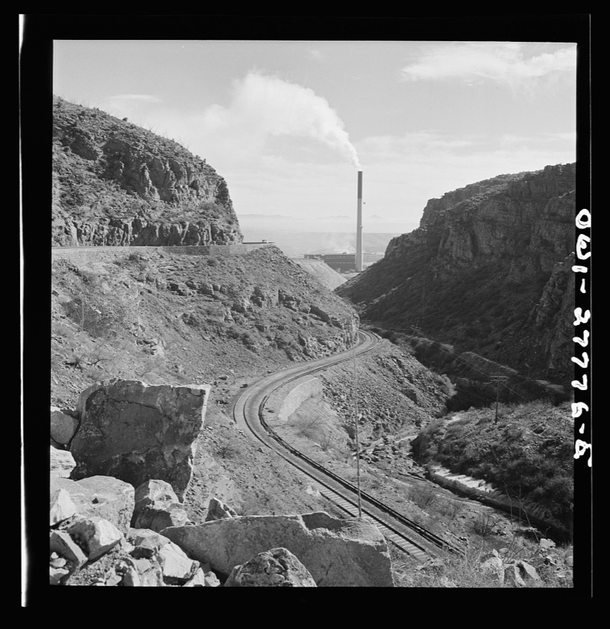 Morenci, Arizona. The copper mine railroad on which the ore is transported to the smelting plant of the Phelps Dodge mining corporation. The plant is in the background