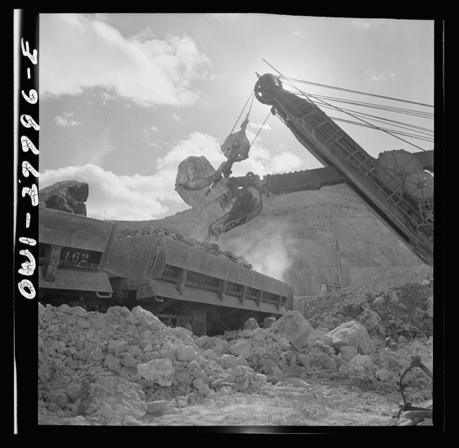 Morenci, Arizona. A huge electric shovel at an open-pit copper mine loading an ore train on its way to the smelter plant of the Phelps Dodge mining corporation