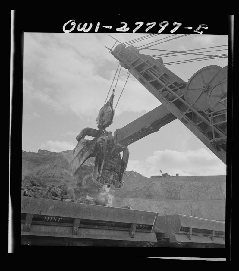 Morenci, Arizona. A huge electric shovel at an open-pit copper mine loading an ore train on its way to the smelter plant of the Phelps Dodge mining corporation