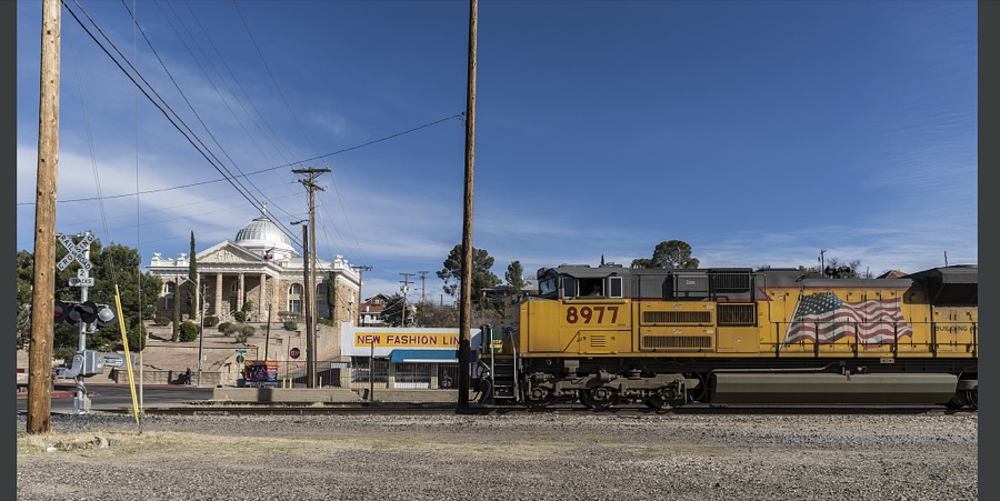 A freight engine passes the Santa Cruz County Courthouse in Nogales, Arizona, a small city on the border across from the much larger city of Nogales, Mexico