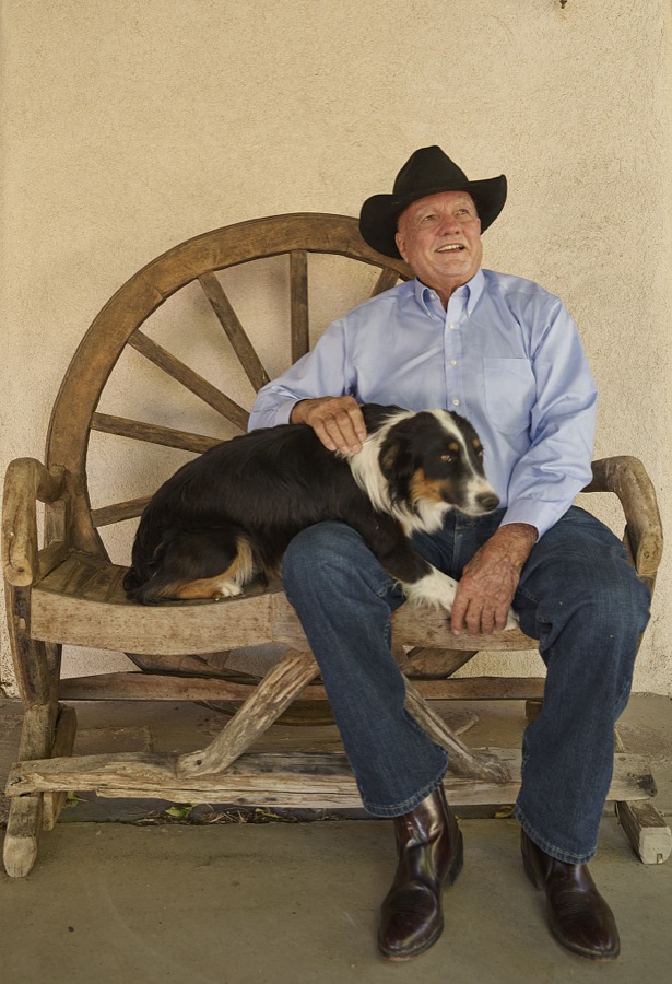 Western rancher and author H. Alan Day relaxes on the porch with sheepdog Vigor (or it might be the dog's brother, Vim) during a visit to Day's boyhood home, the famous Lazy B Ranch in eastern Arizona, on the New Mexico border