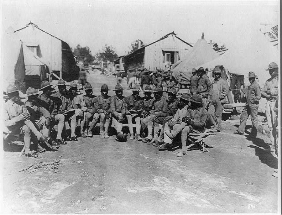 Negro soldier reading to boys who can't read. Camp Gordon, Ga. 1917-18