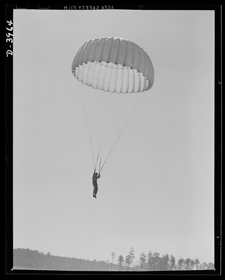 Fort Benning. Parachute troops. Good work! A student paratrooper at Fort Benning, Georgia is about to land in a big, clear space and he's all set to take the ground in the most approved paratrooper style
