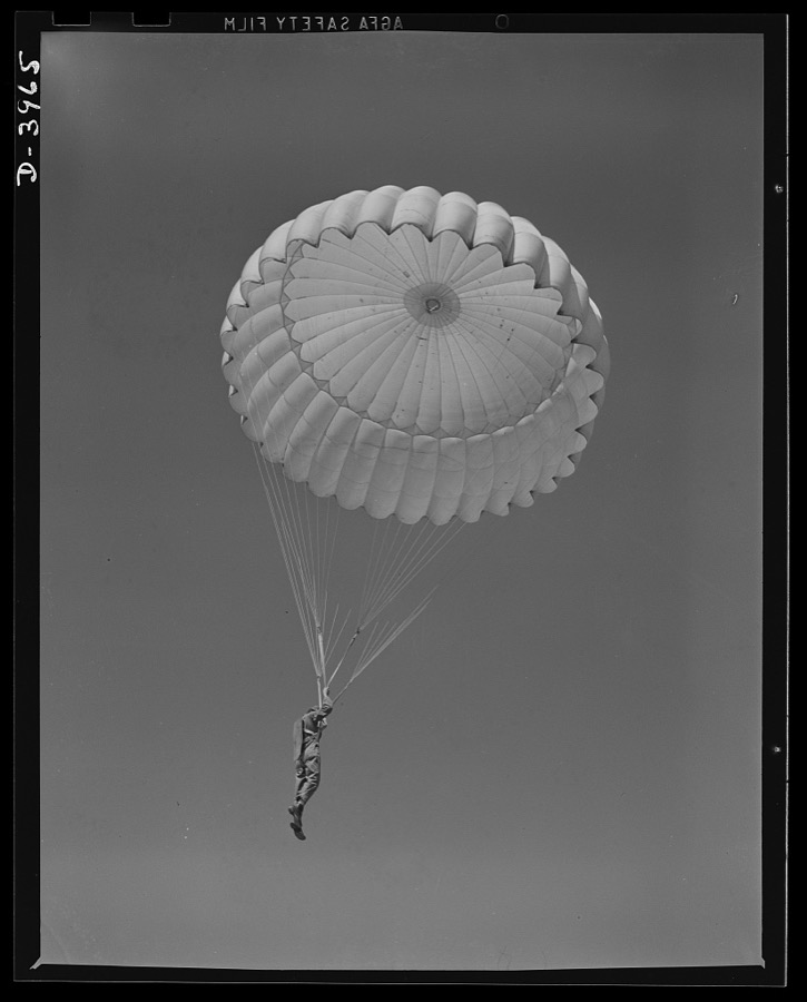 Fort Benning. Parachute troops. Look at that boy come riding a chute like an oldtimer. A student paratrooper at Fort Benning, Georgia has wind currents to think about, and he has his mind on the spot where he wants to land. He's learning to make the kind of landfall he wants