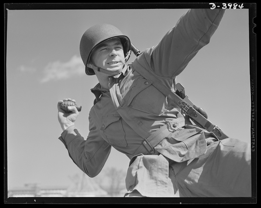 Pineapples for Hitler. A young paratrooper, finishing his training at Fort Benning, Georgia, practices for perfect form in the ticklish art of grenade throwing