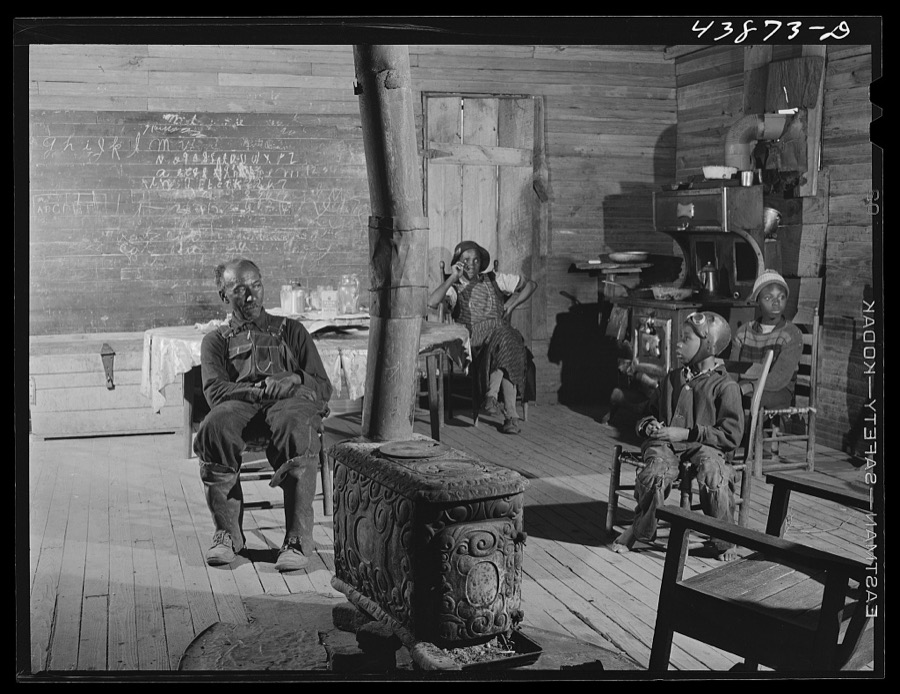Negro preacher and his wife live in this converted schoolhouse with two grandchildren. The rest of their children have all left the county. Heard County, Georgia