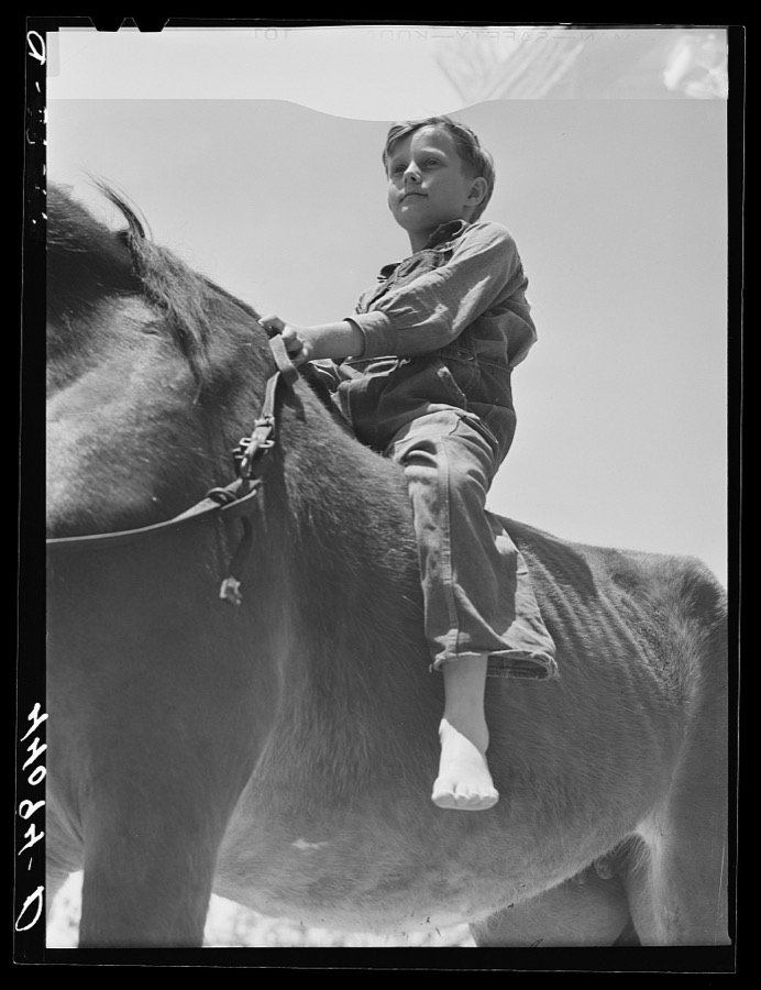 Colie Smith gets a ride on one of two horses owned by the Smith family. Carroll County, Georgia