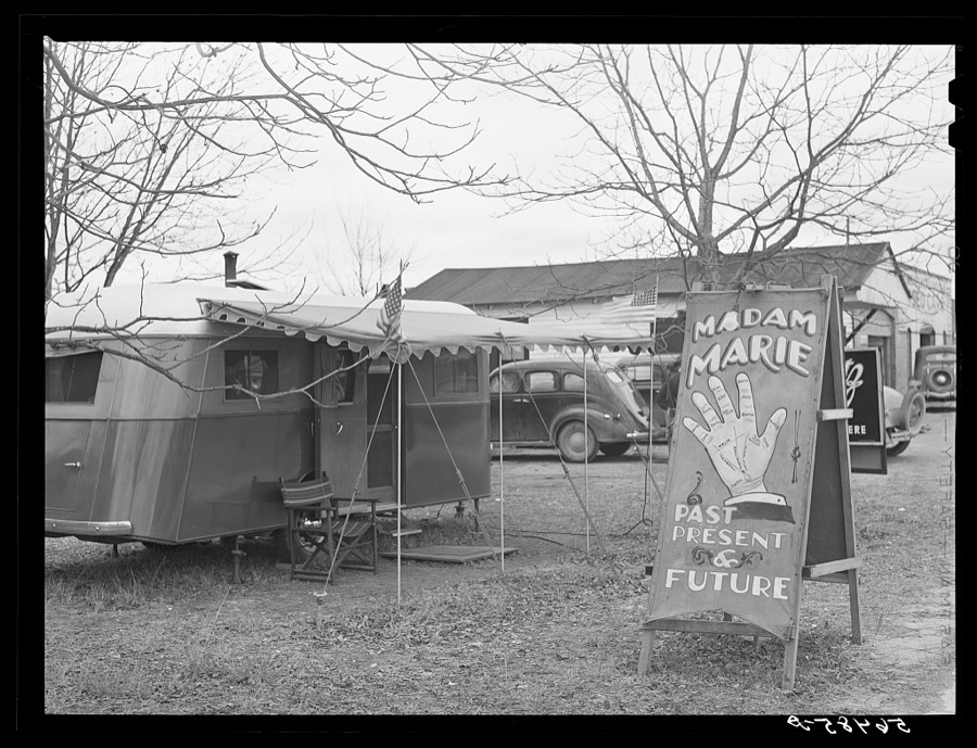 Fortune teller's sign and trailer near trailer camps where Army men and construction workers live on highway near Fort Benning, Columbus, Georgia