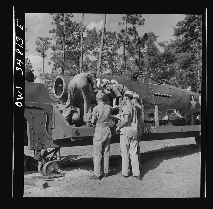 Warner Robins, Georgia. Air Service Command, Robins Field. Practicing picking up and loading of an old P-39 with a C3 truck and trailer