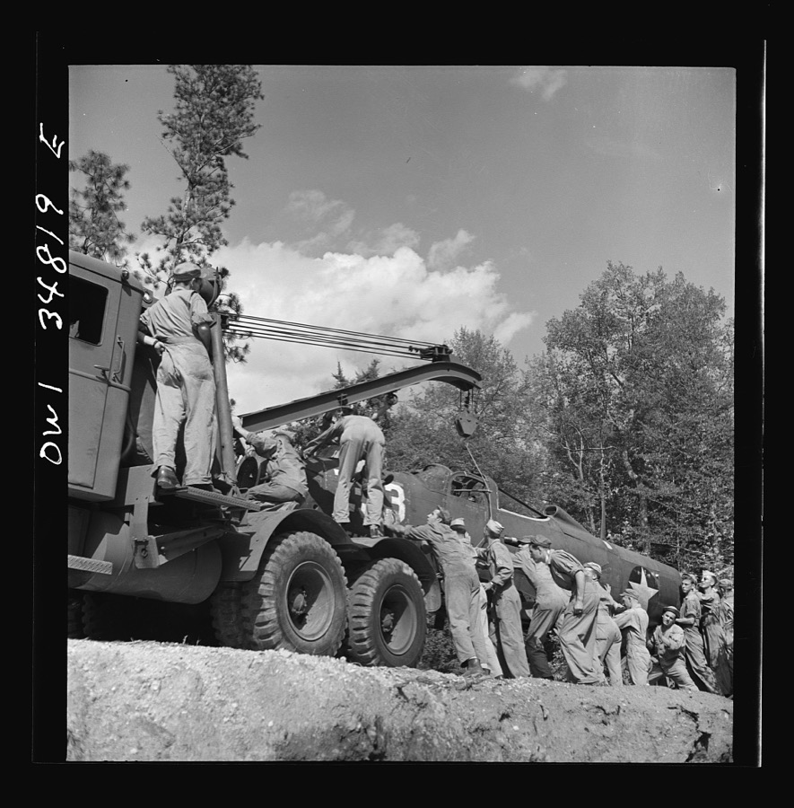 Warner Robins, Georgia. Air Service Command, Robins Field. Practicing picking up and loading of an old P-39 with a C3 truck and trailer
