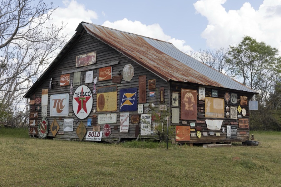 Barn in Sumter County, Georgia, festooned with the owner's collection of old signs