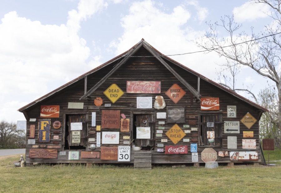 Barn in Sumter County, Georgia, festooned with the owner's collection of old signs