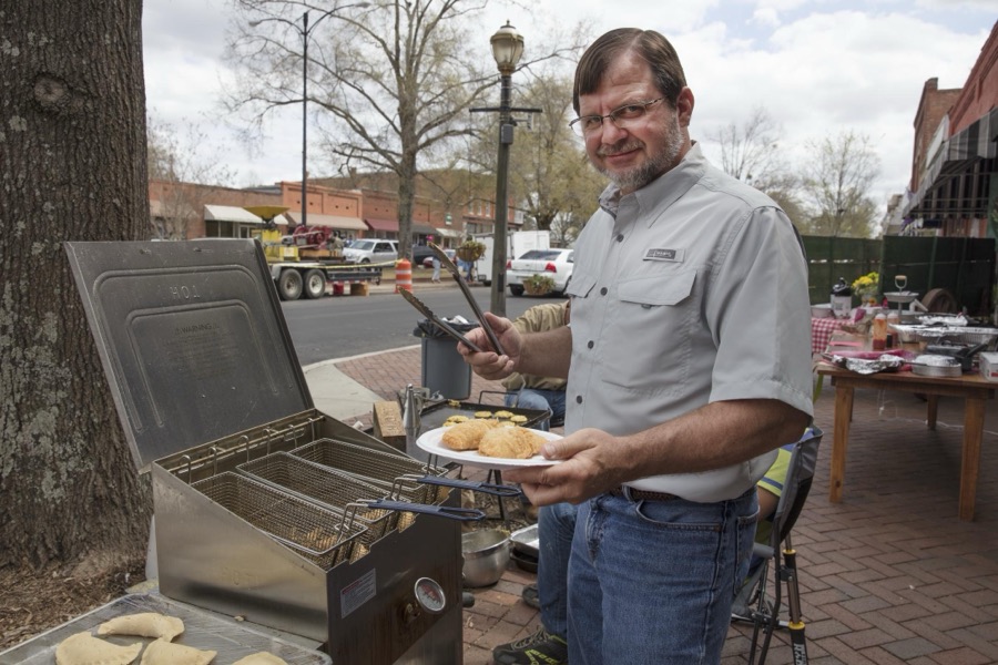 Ron Shultz samples fried fruit pies during Louisville Heritage Days in Louisville, a town in northeastern Georgia, named for French King Louis XVI in appreciation for French assistance to the colonists during the American Revolution