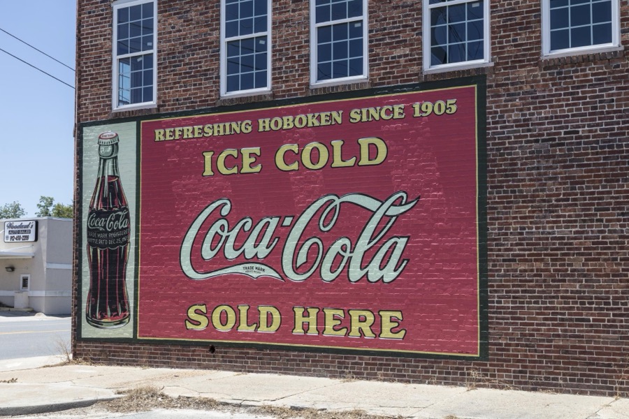 Old Coca-Cola sign with some local identification in Hoboken, Georgia
