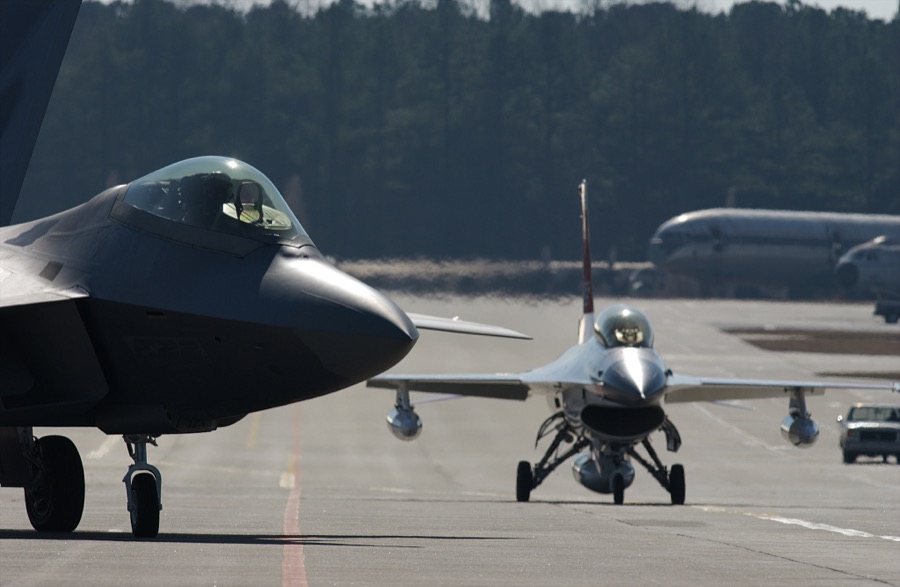 An F/A-22 Raptor and an F-16 chase plane prepare for take-off from an airstrip at Lockheed Martin in Marietta, Georgia