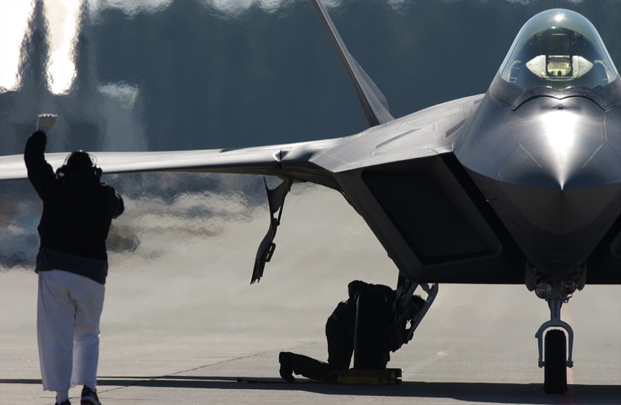 An F/A-22 Raptor and an F-16 chase plane prepare for take-off from an airstrip at Lockheed Martin in Marietta, Georgia