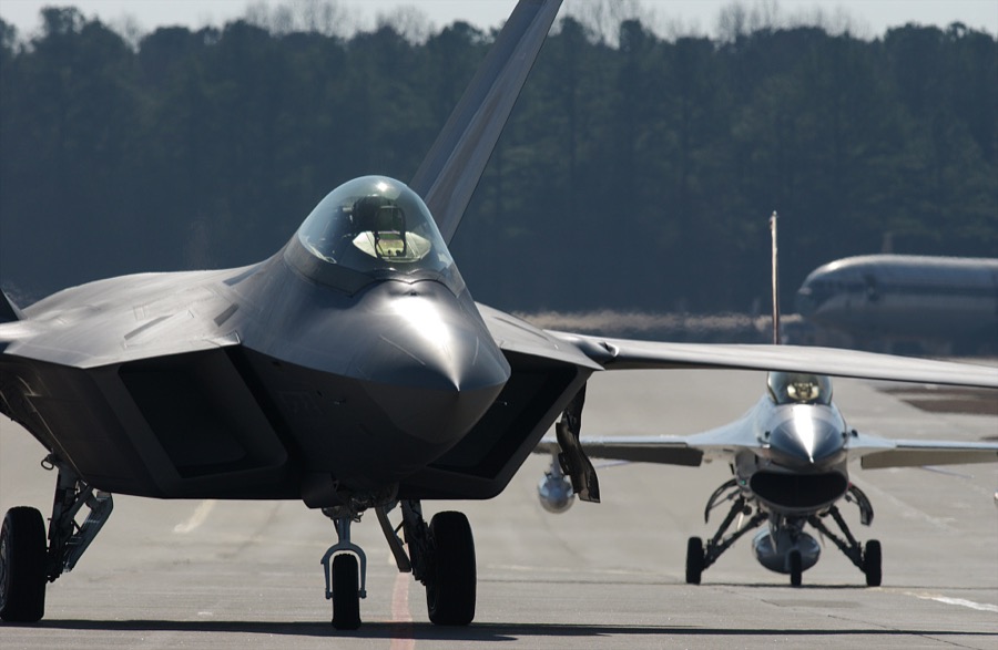 An F/A-22 Raptor and an F-16 chase plane prepare for take-off from an airstrip at Lockheed Martin in Marietta, Georgia