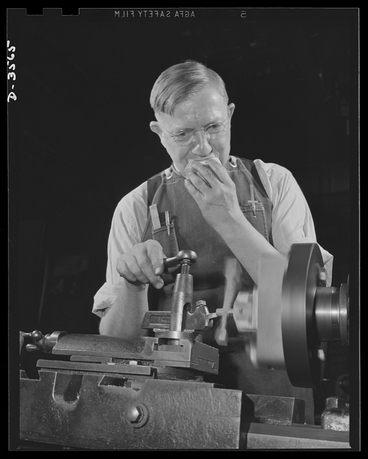 Conversion. Watch cases to war production. No time out for eating on an overtime job. Making bomb sights comes easy to him, for he has had long experience in precision work at a commercial Kentucky watch case factory now entirely on a war production basis. Wadsworth Watch Company, Louisville, Kentucky