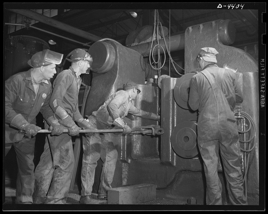 Production. Pipe fittings. Forging shop crew of a Midwest plant serve the world's largest machine of its kind a nine inch upsetter. This machine is used for forging 75 mm shells for the Army. Tube Turn Incorporated