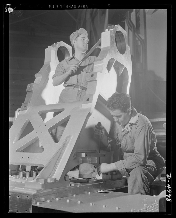 Production. Naval gun mounts. The chassis of a large naval gun mount nears completion as workmen of a Midwest machine shop perform final scraping and fitting operations. Westinghouse, Louisville
