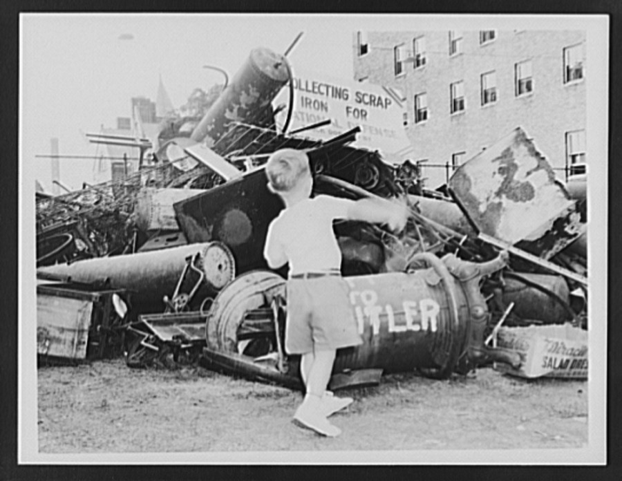 Ashland, Kentucky. A scrap pile where iron has been collected for national defense, showing a small boy contributing something, probably a toy