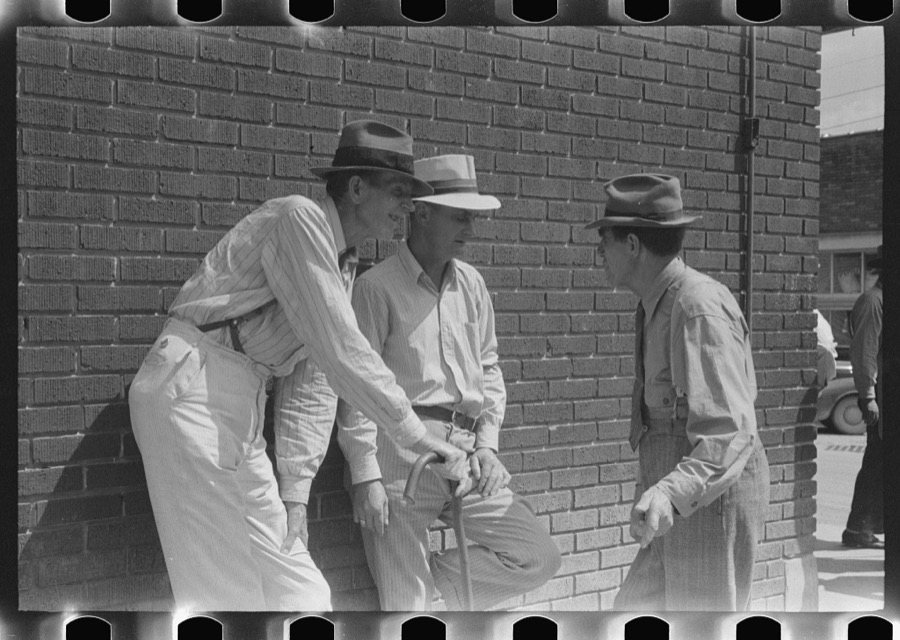 Mountain people exchanging news and greetings on the street corner in center of town on Saurday afternoon and court day. Campton, Wolfe County, Kentucky