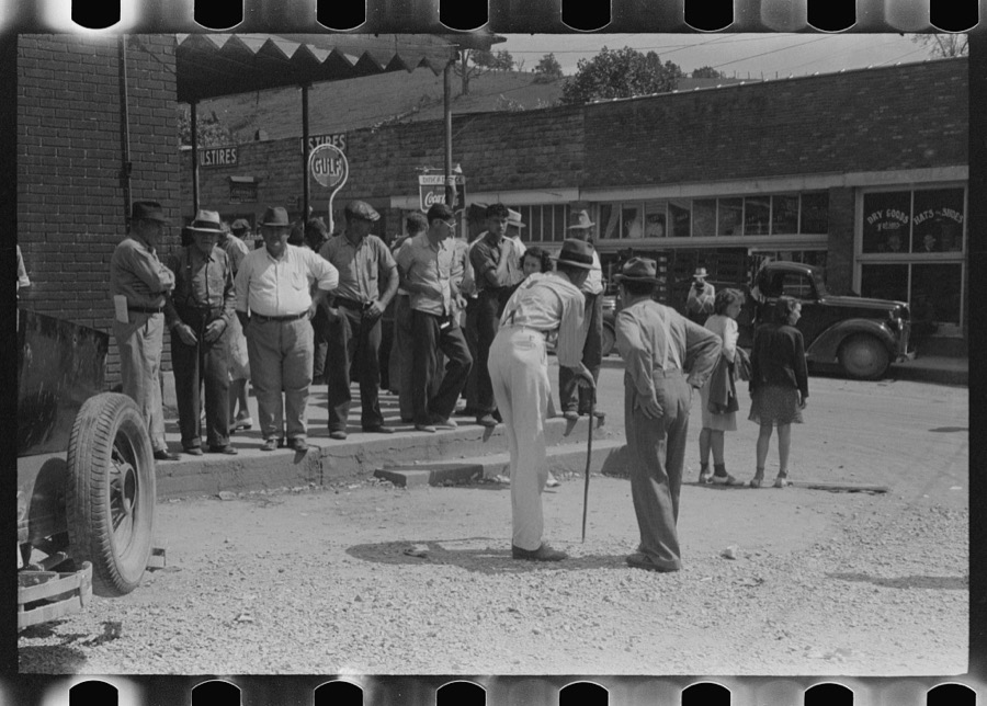 Mountain people exchanging news and greetings on the street corner in center of town on Saurday afternoon and court day. Campton, Wolfe County, Kentucky