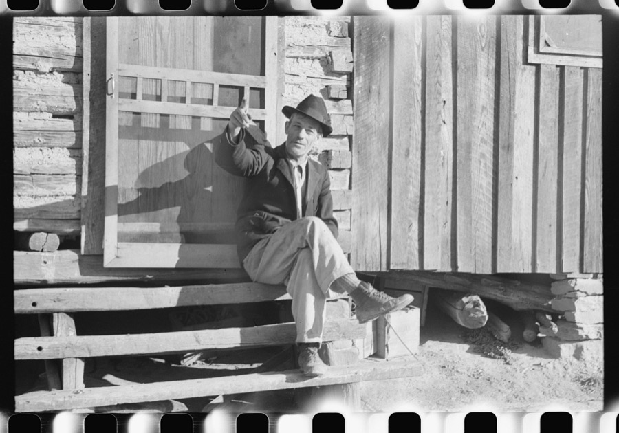 Noah Garland sitting on the steps of his son's home, Southern Appalachian Project, near Barbourville, Knox County, Kentucky