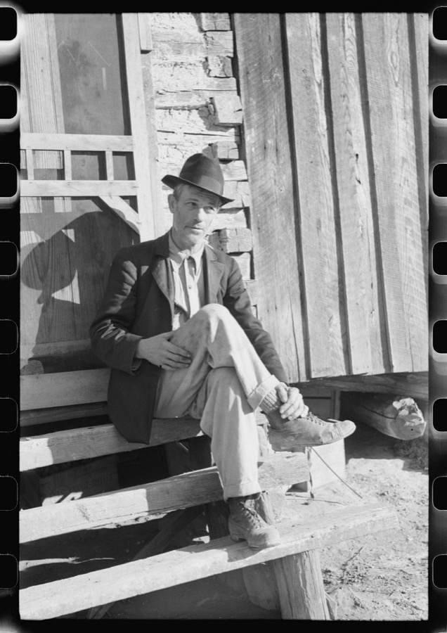 Noah Garland sitting on the steps of his son's home, Southern Appalachian Project, near Barbourville, Knox County, Kentucky