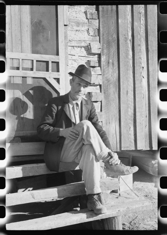 Noah Garland sitting on the steps of his son's home, Southern Appalachian Project, near Barbourville, Knox County, Kentucky