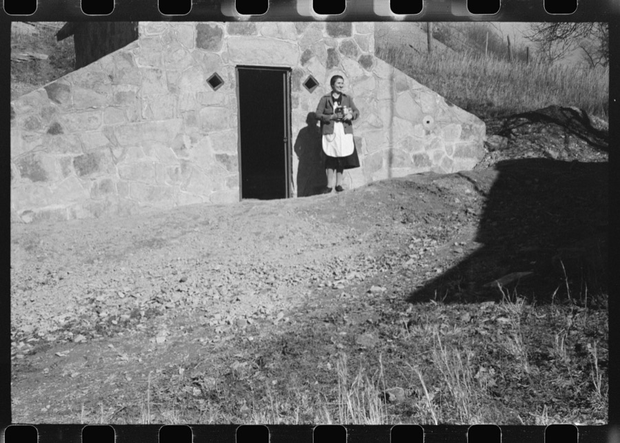 Mrs. S. Castle or Mrs. William S. Allen with canned goods in front of new storage house her husband built on their farm with FSA (Farm Security Administration) help. Southern Appalachian project, near Barbourville, Knox County, Kentucky