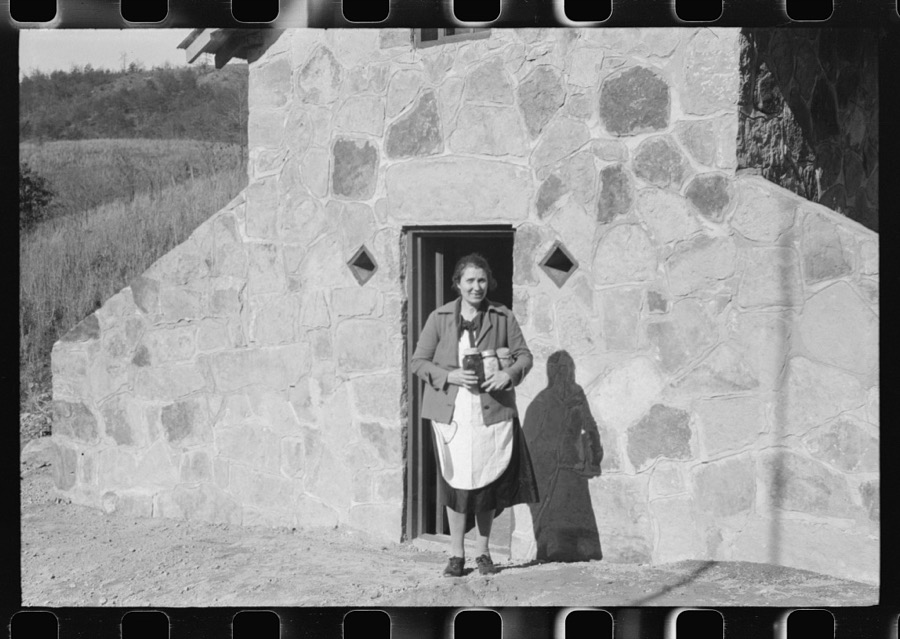 Mrs. S. Castle or Mrs. William S. Allen with canned goods in front of new storage house her husband built on their farm with FSA (Farm Security Administration) help. Southern Appalachian project, near Barbourville, Knox County, Kentucky