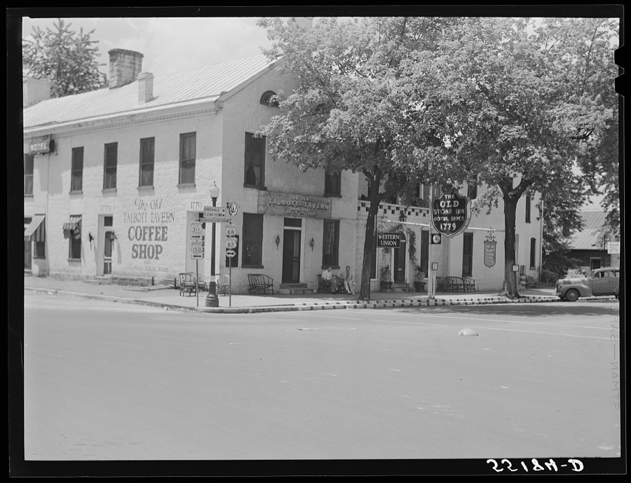 Townspeople visiting while sitting in front of Old Talbott Tavern on Saturday afternoon. Bardstown, Kentucky