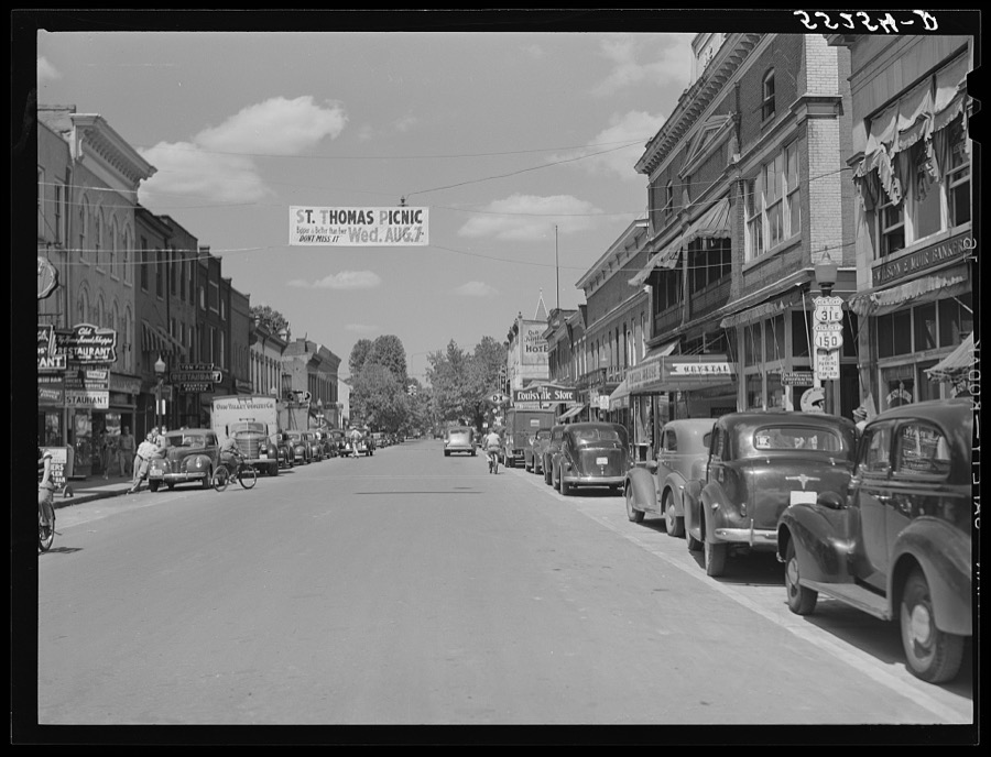 Center of town with banner advertising church picnic. Bardstown, Kentucky