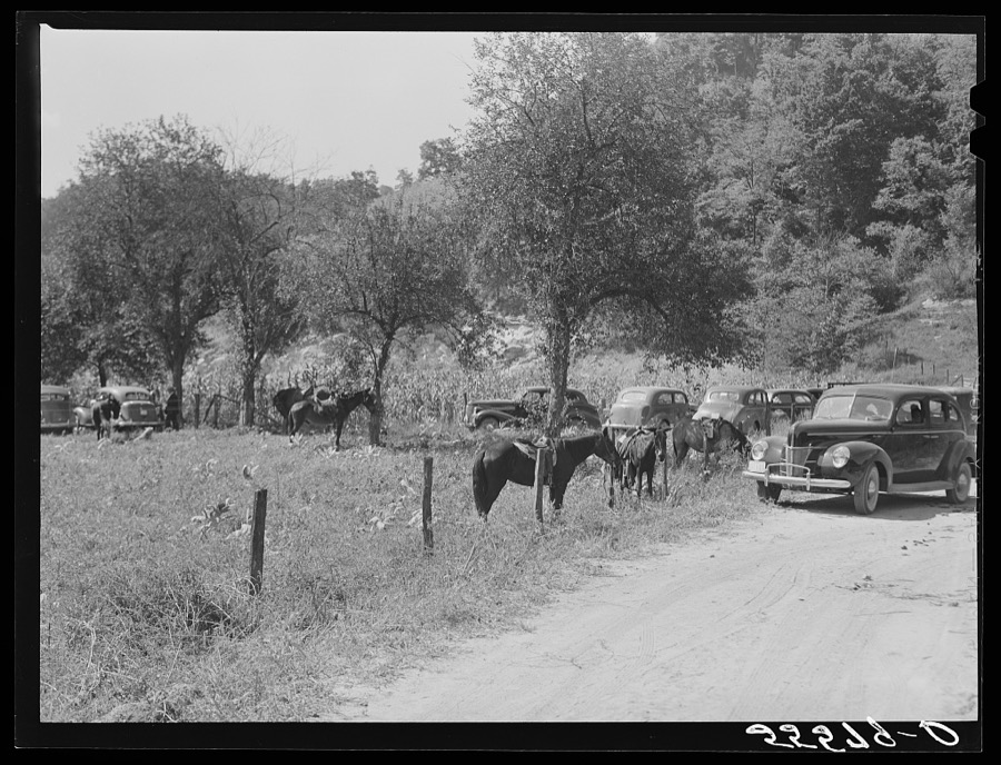 Horse, mules and automobiles standing outside mountain family's yard during a memorial meeting up Frozen Creek, near Jackson, Breathitt County, Kentucky. See general caption number one