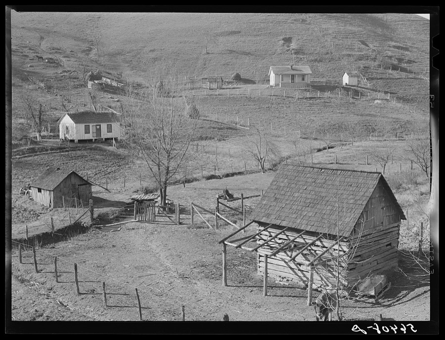 Noah Garland's barns and home on the hillside. His neighbor's house is on the right. Southern Appalachian Project near Barbourville, Knox County, Kentucky