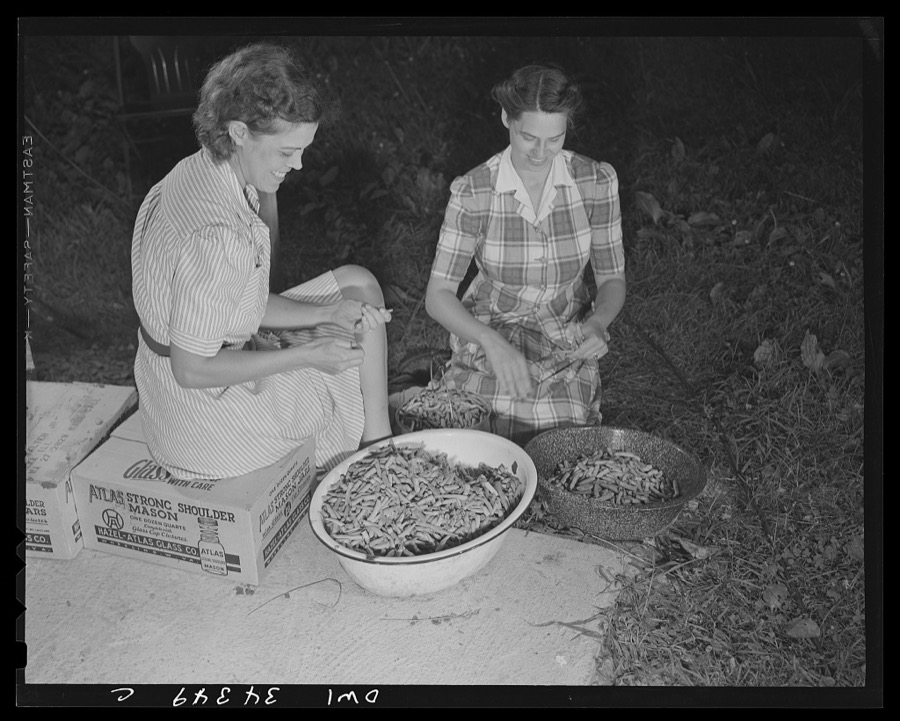 Jeffersontown, Kentucky. The Jefferson County ommunity cannery, started by the WPA (Work Projects Administration), now conducted by the state (?) vocational education department. Women pay three cents each for cans and two cents per can for use of the pressure cooker. Left to right; Mrs. J. Payater Holt and Mrs. Hampden Lawsen of Louisville preparing string beans for canning. The beans were raised by Mrs. Holt in her victory garden