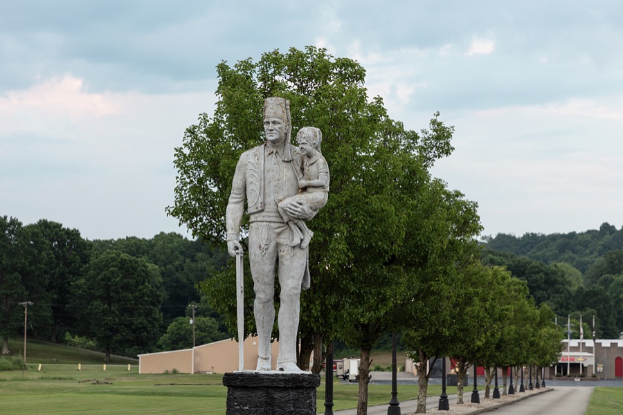 Statue of a Shriner, a member of the fraternal Masonic order, holding a crutch in one hand and a small child in another, outside the El Hasa Shrine Temple in Ashland, Kentucky