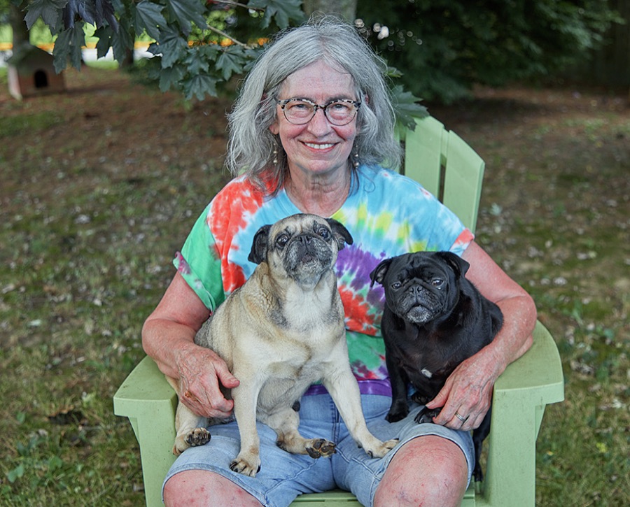 Val Morgan, a retired attorney for the U.S. agency that oversees federal health-care payments, relaxes with two of her three wrinkly-faced, short-muzzle pug dogs, 14-year-old Loretta, left, and 17-year-old Gus