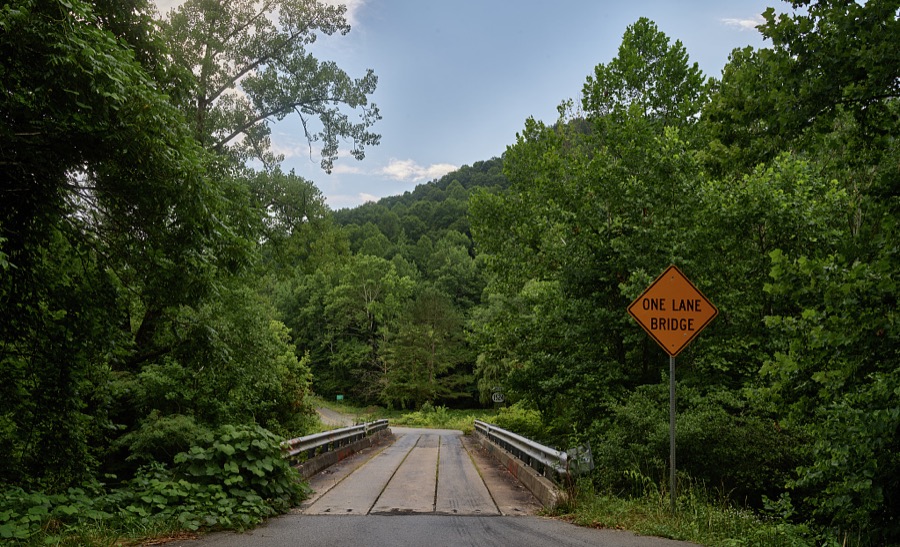 As the sign says, this is a (narrow wooden) one-lane bridge across a mountain creek in woods near Manchester, Kentucky