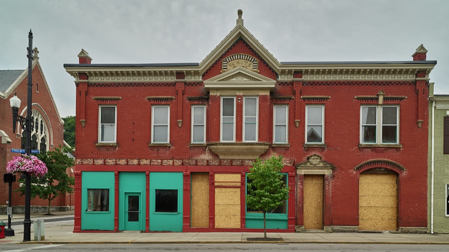The "White Block" row of buildings in Maysville, Kentucky, featuring a finely carved stone door pediment and an elaborate cast-iron pilastered storefront