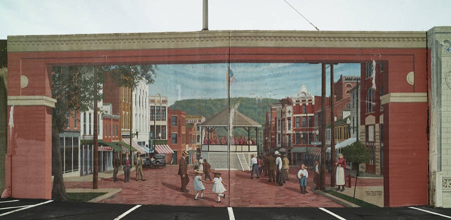 A mural depicting a gathering at the Market Street bandstand, one of 10 panels painted by artist Robert Dalford and his team on panels along the Ohio River floodwall in Maysville, Kentucky